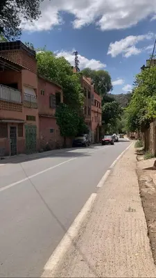 an empty street with cars parked on the side of the road at Ourika in Ourika