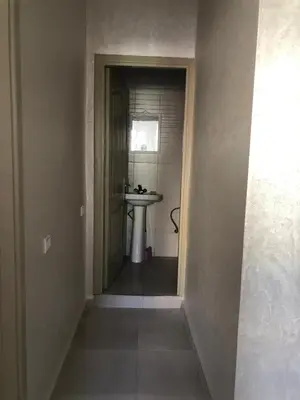 a hallway leading to a bathroom with a sink at Apartment with beautiful view in the center of Marrakech in Oulad Akkou
