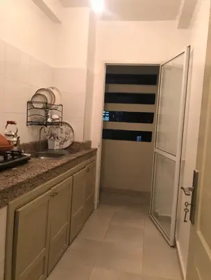 a kitchen with a sink and a glass door at Apartment with beautiful view in the center of Marrakech in Oulad Akkou