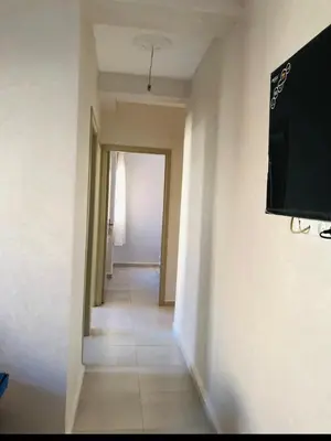 a hallway with a flat screen tv on a wall at Apartment with beautiful view in the center of Marrakech in Oulad Akkou
