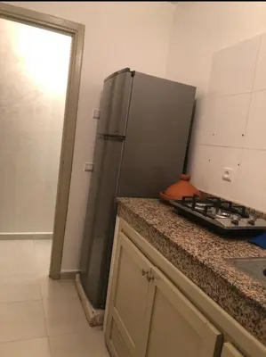 a kitchen with a stainless steel refrigerator on a counter at Apartment with beautiful view in the center of Marrakech in Oulad Akkou
