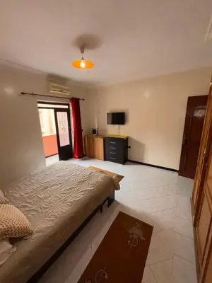 a bedroom with a bed and a television in it at Belle Chambre Dans Une Villa in Oulad Akkou