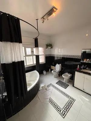 a large bathroom with a tub and a toilet at Belle Chambre Dans Une Villa in Oulad Akkou