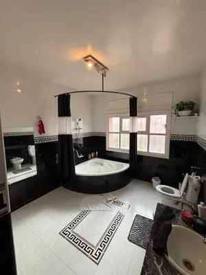 a large bathroom with a tub and a sink at Belle Chambre Dans Une Villa in Oulad Akkou