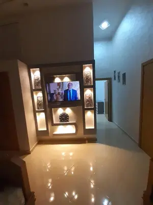 a room with a television in a building at appartement complexe farah airoport in Oulad Akkou