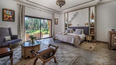 a bedroom with a king sized bed and a living room at Villa Hiba Luxury & Paddle in Najem