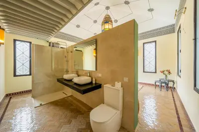a bathroom with a toilet and a sink at Villa Hiba Luxury & Paddle in Najem