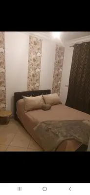 a bedroom with a large bed in a room at Appartement à côté la plage in Oulad Akkou