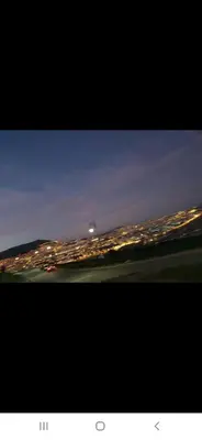 a view of a city at night with lights at Appartement à côté la plage in Oulad Akkou