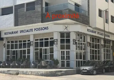 a building with a car parked in front of it at Appartement à proximité de tout ! in Fès