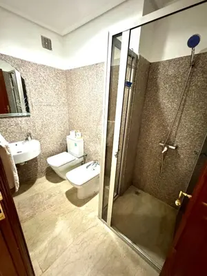 a bathroom with a shower and a toilet and a sink at Appartement à proximité de tout ! in Fès
