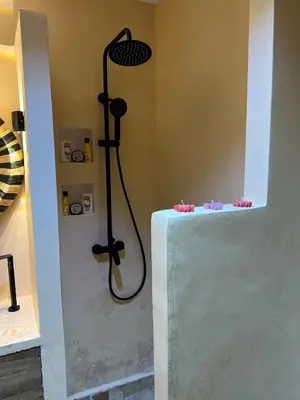 a shower in the corner of a bathroom at Chic accommodation in Moroccan style in Oulad Akkou