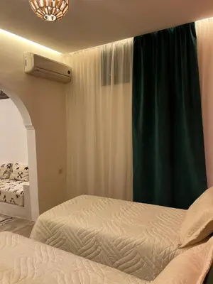 a bedroom with a bed and a green curtain at Chic accommodation in Moroccan style in Oulad Akkou