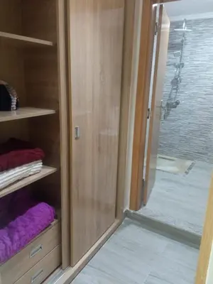a glass door to a shower in a room at Villa Close to Lhdim Square in Meknès