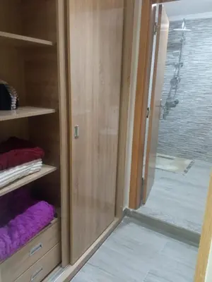 a glass door of a shower with purple towels at Villa Close to Lhdim Square in Meknès