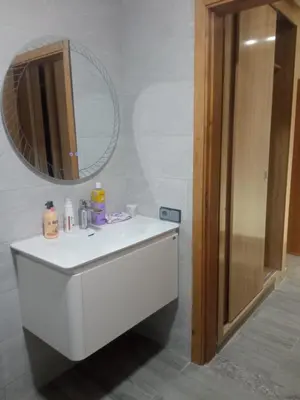 a bathroom with a white sink and a mirror at Villa Close to Lhdim Square in Meknès