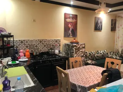a kitchen with a table and a stove and a table and a table at المغرب in Oulad Akkou