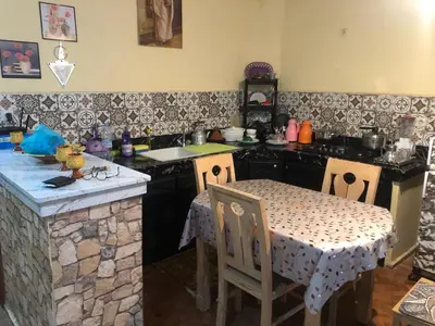 a kitchen with a table and a kitchen with a stone counter at المغرب in Oulad Akkou