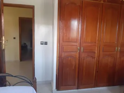 a pair of wooden cabinets in a bedroom at Cosy villa in Oulad Akkou