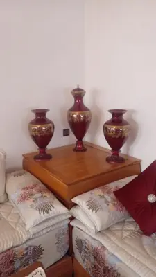 two vases sitting on wooden shelves in a room at Cosy villa in Oulad Akkou