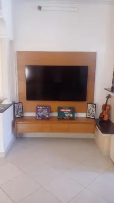 a flat screen tv sitting on top of a wooden bench at Cosy villa in Oulad Akkou