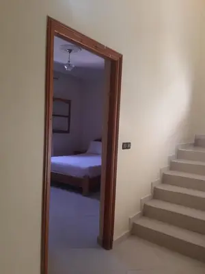 a mirror in a room with a bed and a bedroom at Cosy villa in Oulad Akkou