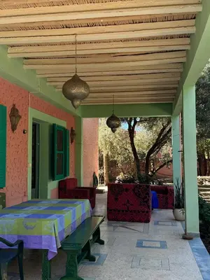 a patio with a table and a wooden ceiling at Villa Zaïtoun in Aït Ourir