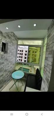 a view of a living room with a table and chairs at Appartement avec ,1 minte de la plage in Oulad Akkou