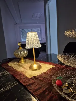 a table with a lamp on top of a table at Le Nid Doré, Appartement Chic au Centre de Meknès in Meknès