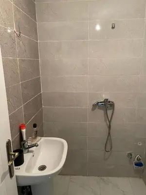 a small bathroom with a sink and a shower at Le Nid Doré, Appartement Chic au Centre de Meknès in Meknès