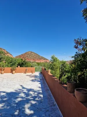 a patio with mountains in the background at Villa Jenate Serenitée et paix in Timalizèn