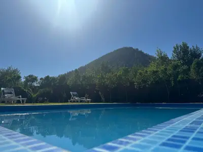 a swimming pool with a mountain in the background at Villa Jenate Serenitée et paix in Timalizèn
