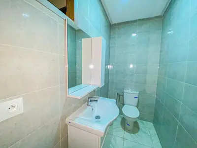 a bathroom with a white toilet and a sink at Villa de luxe à louer Marrakech in Ourika