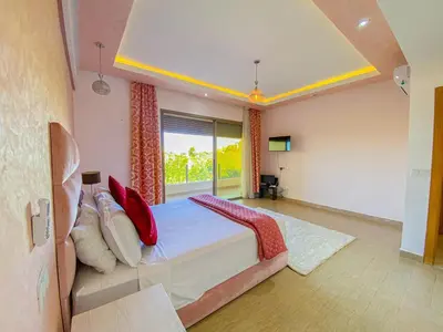 a bedroom with a large bed and a window at Villa de luxe à louer Marrakech in Ourika