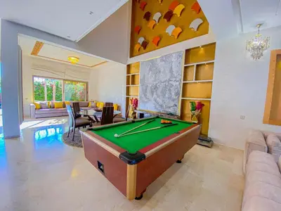 a living room with a pool table in it at Villa de luxe à louer Marrakech in Ourika