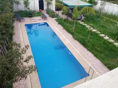an overhead view of a large blue swimming pool at Villa tagmouti in Aghmat