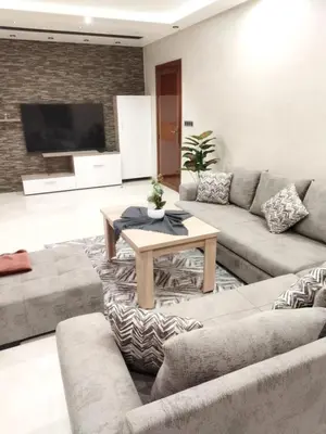 a living room with a couch and a table at حي السلام أكادير in Oulad Akkou