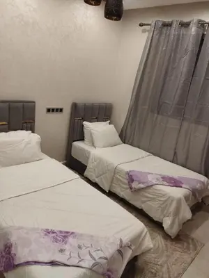 two beds sitting next to each other in a room at حي السلام أكادير in Oulad Akkou