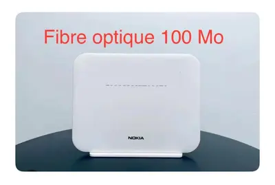 a white router with the text fibre optic too mo at Luxueux Appartement Prestigia avec Wifi 100 M in Fès
