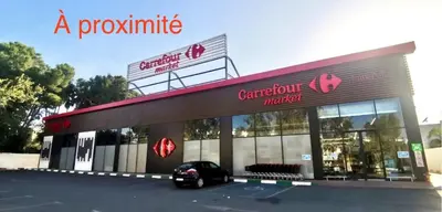 a supermarket with a car parked in front of it at Luxueux Appartement Prestigia avec Wifi 100 M in Fès