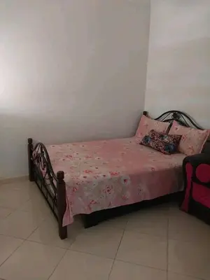 a small bed with pink sheets and pillows on it at العنوان حي المقاومة بلوك دال رقم 389 مكرر ورزازات in Oulad Akkou