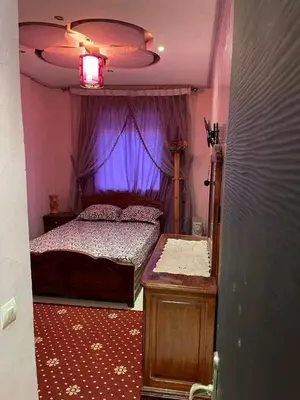 a bedroom with a bed and a purple curtain at العنوان حي المقاومة بلوك دال رقم 389 مكرر ورزازات in Oulad Akkou