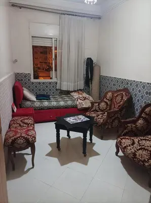 a living room with a couch and chairs and a table at La joie in Oulad Akkou