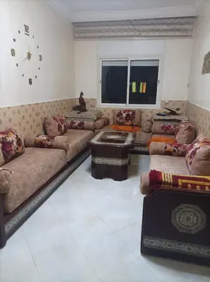 a large living room with couches and a window at La joie in Oulad Akkou