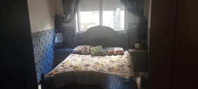 a bedroom with a bed and a window at La joie in Oulad Akkou