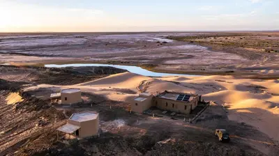 an aerial view of a building in the desert at Dunes Clave in Hassilabied