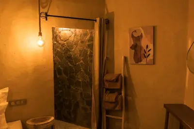 a shower with a glass door in a bathroom at Dunes Clave in Hassilabied