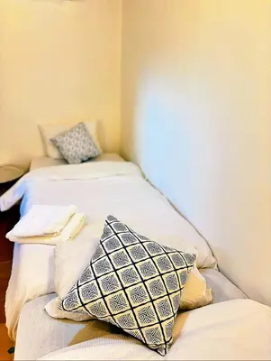 two beds sitting next to each other in a room at Riad Ayoub Fes in Fès