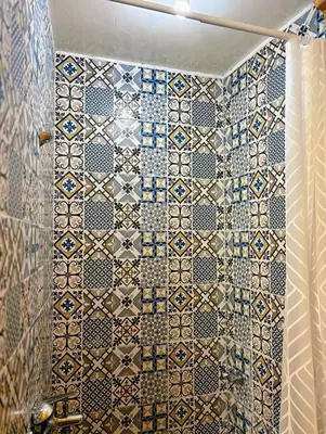 a bathroom with a tiled wall in a shower at Riad Ayoub Fes in Fès