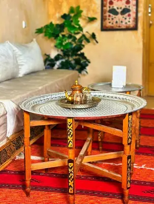 a coffee table in a living room with a bed at Riad Ayoub Fes in Fès